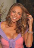 Mariah Carey in reveling pink dress shows her legs and big cleavage as she lights up the Empire State Building to celebrate her new album in New York City